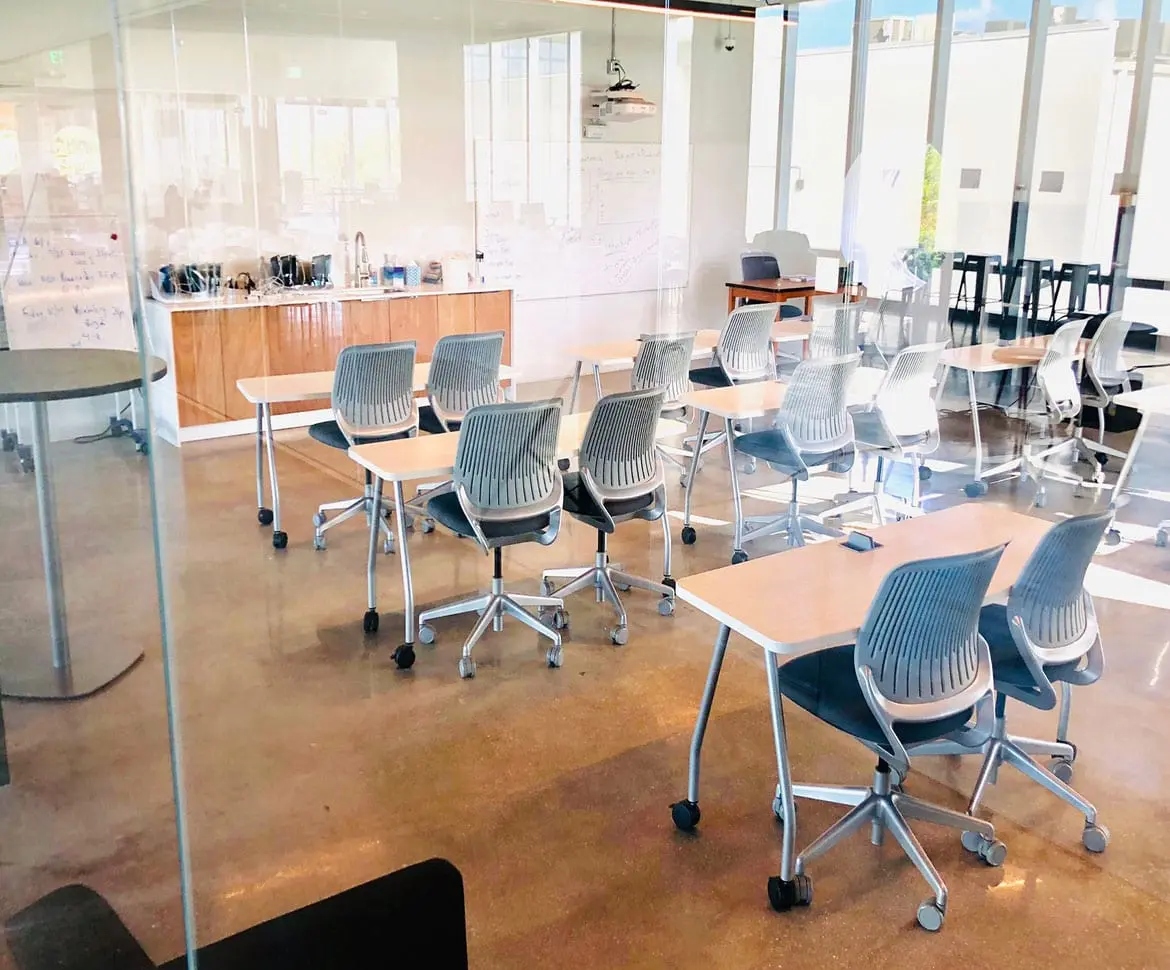 Modern classroom with polished concrete flooring and modular furniture