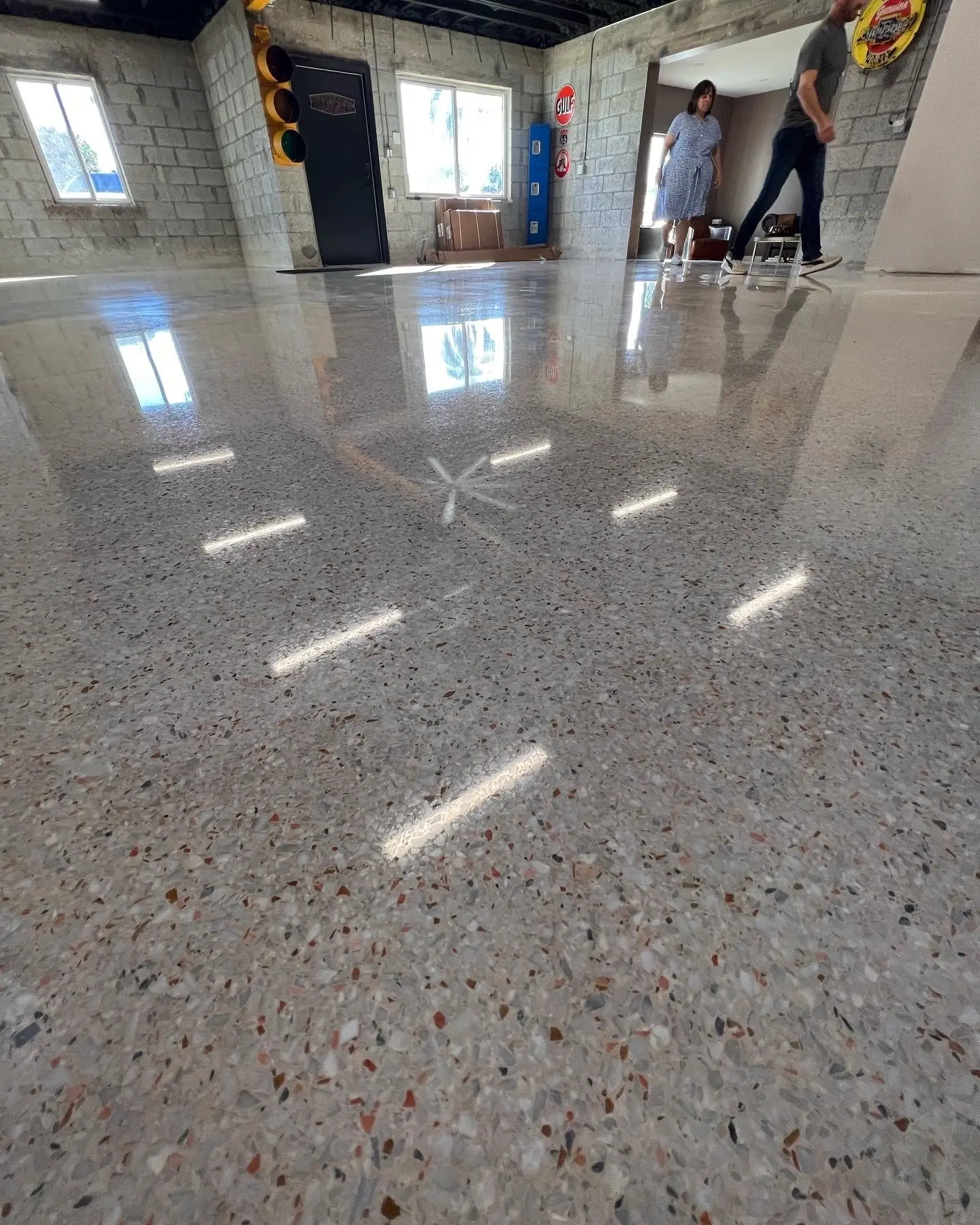 Polished epoxy terrazzo floor reflecting ceiling lights in a spacious commercial room