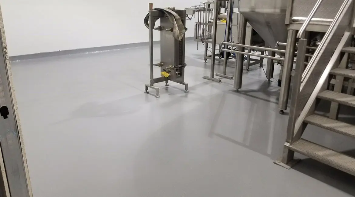 Chemical-resistant urethane floor coating in an industrial manufacturing setting